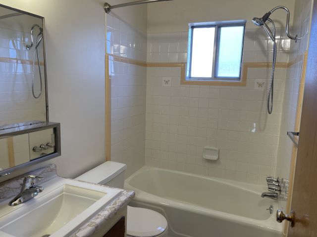 Bathroom is clean with tile tub surround